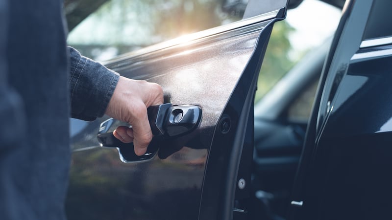 Close up of a male hand opening a car door