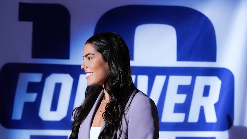 Former Washington guard and current Las Vegas Aces player Kelsey Plum smiles during her jersey...