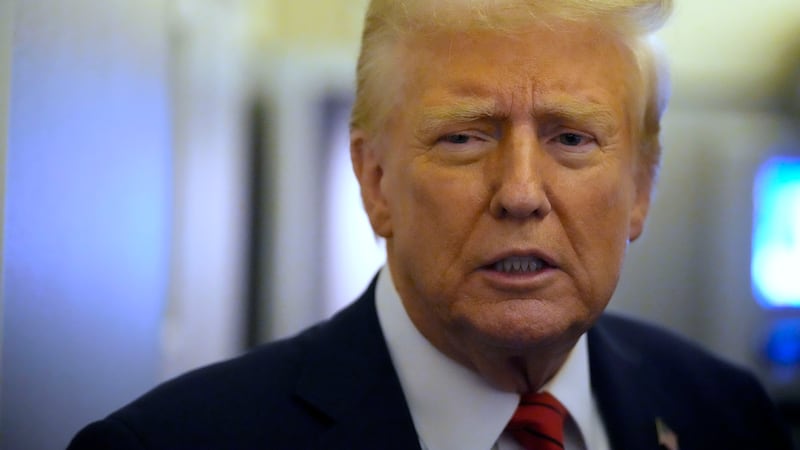 President Donald Trump speaks to reporters aboard Air Force One en route from Miami to Joint...
