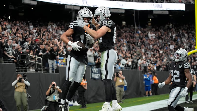 Las Vegas Raiders wide receiver Jakobi Meyers, middle left, is congratulated by tight end...