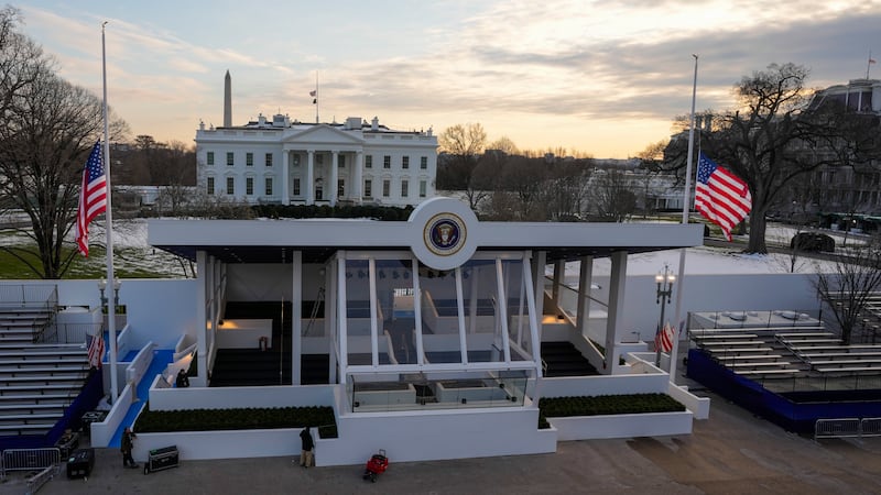 Workers continue with the finishing touches on the presidential reviewing stand on...