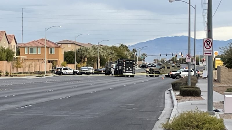 A white vehicle seen sandwiched between two SWAT vehicles near the scene of an OIS near...