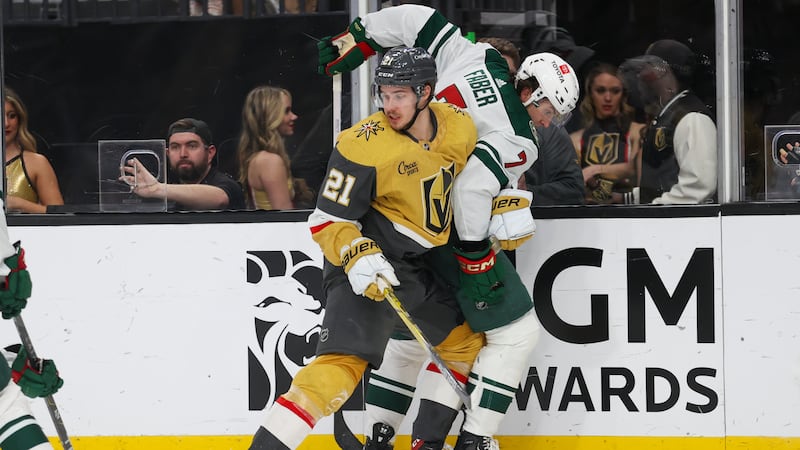 Vegas Golden Knights center Brett Howden (21) collides with Minnesota Wild defenseman Brock...