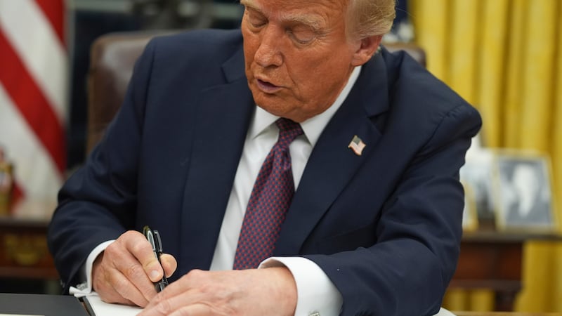 President Donald Trump signs an executive order on birthright citizenship in the Oval Office...