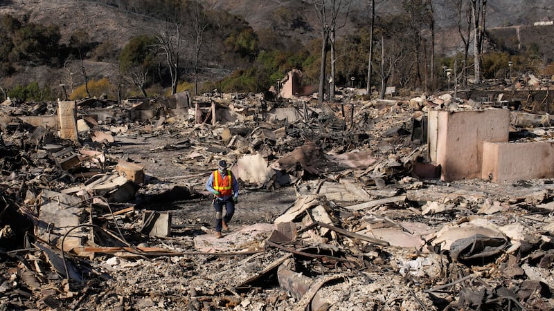 A worker surveys the damage from the Palisades Fire in the Pacific Palisades neighborhood of...