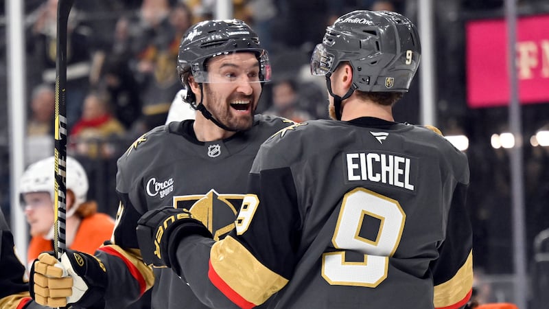 Vegas Golden Knights right wing Mark Stone, left, celebrates with center Jack Eichel (9) after...