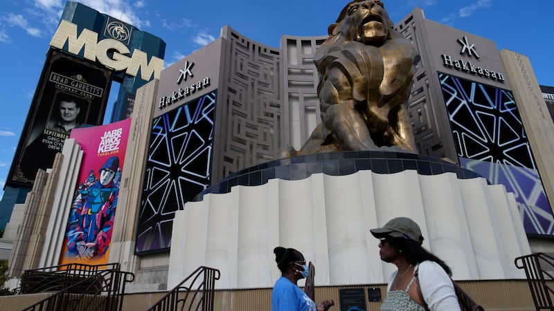 People walk by the MGM Grand hotel-casino Wednesday, Sept. 13, 2023, in Las Vegas. A...