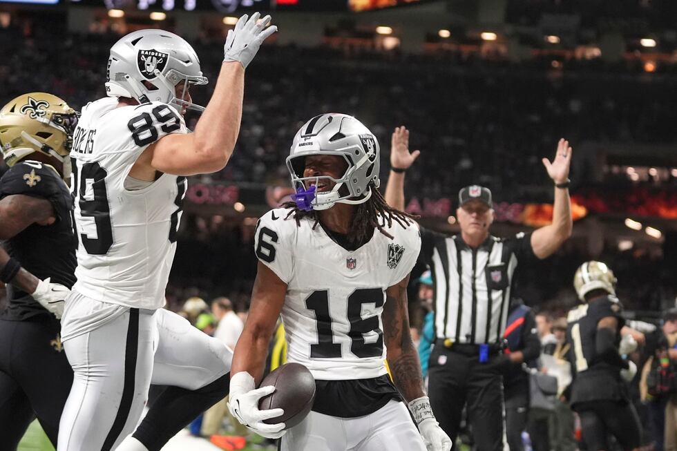 Las Vegas Raiders wide receiver Jakobi Meyers (16) celebrates with teammate tight end Brock...