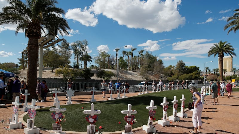 People visit a makeshift memorial for victims of the Oct. 1, 2017, mass shooting in Las Vegas,...